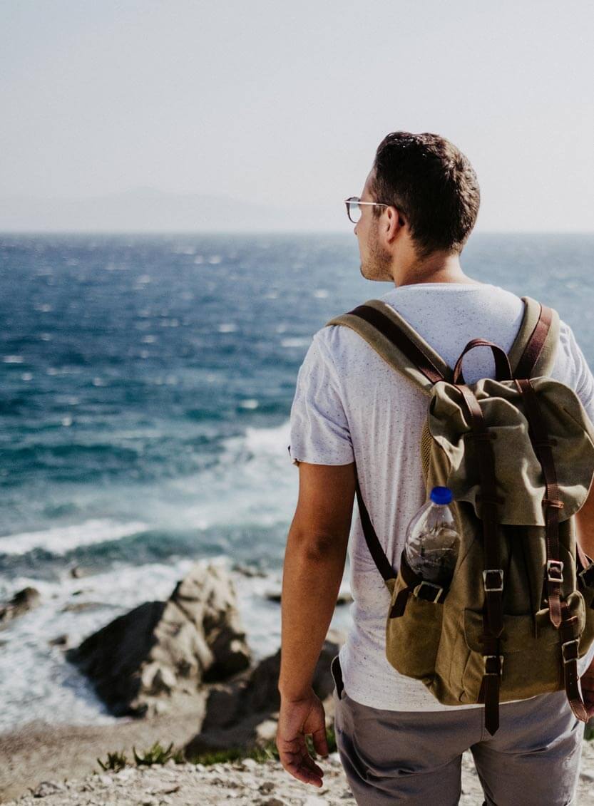 Man hiking on a rocky beach
